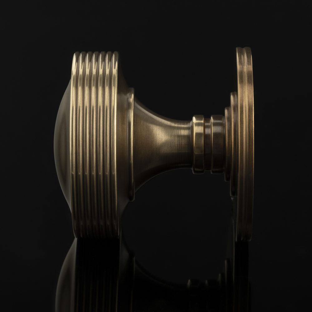 solid brass door knob in mid antique brass waxed